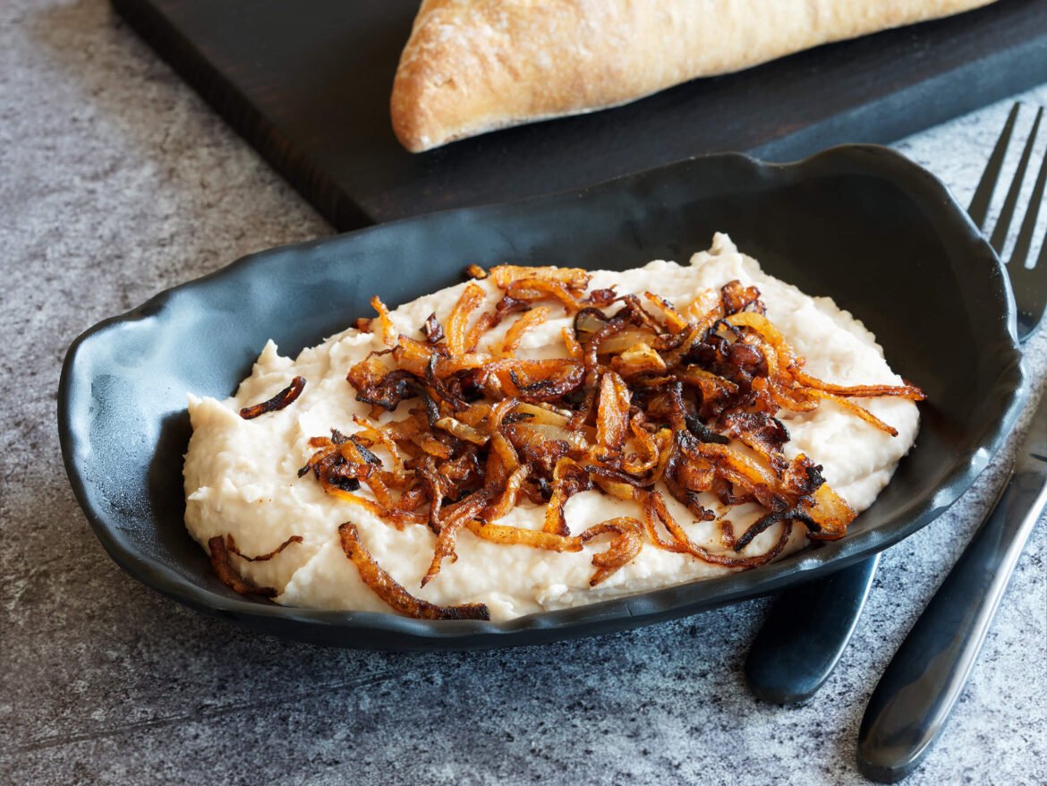 Romanian white bean dip with garlic, vegetable oil, with a topping of sauteed onions and tomato paste